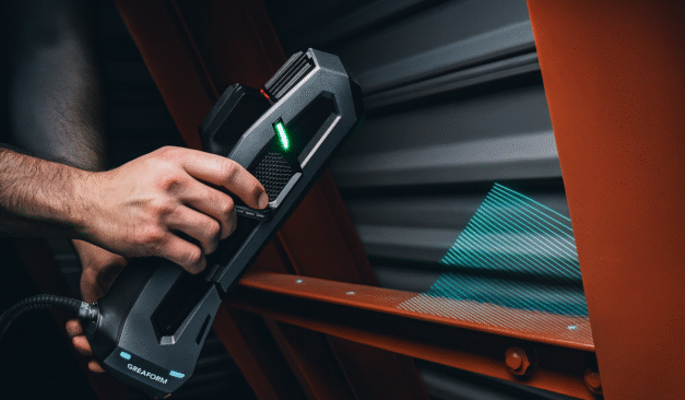 Technician using a Creaform 3D scanner to capture precise digital measurements of a steel structure in Ontario.