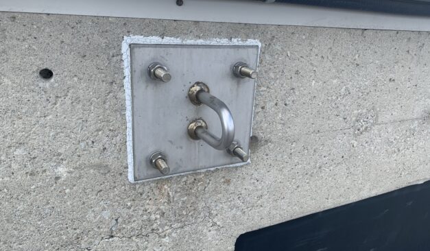 permanent roof anchors installed on a flat industrial rooftop for fall protection inspection in Ontario.