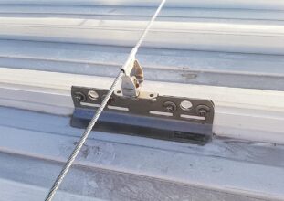 Industrial rooftop fall protection system with anchors, guardrails, and ladder access in Ontario commercial facility