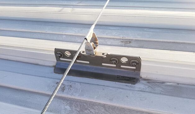 Industrial rooftop fall protection system with anchors, guardrails, and ladder access in Ontario commercial facility