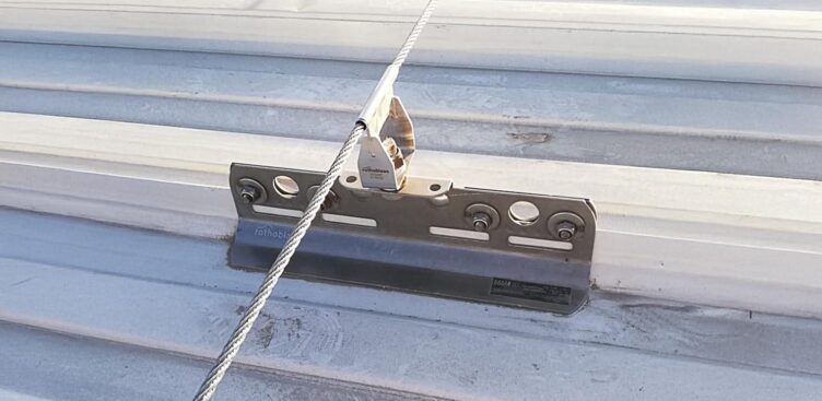 Industrial rooftop fall protection system with anchors, guardrails, and ladder access in Ontario commercial facility