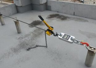 Roof anchor load testing using calibrated dynamometer on industrial rooftop in Ontario