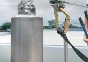 Horizontal lifeline system with cable and anchors installed on industrial rooftop in Ontario