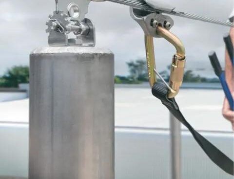 Horizontal lifeline system with cable and anchors installed on industrial rooftop in Ontario