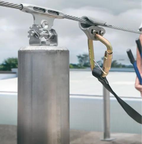 Horizontal lifeline system with cable and anchors installed on industrial rooftop in Ontario
