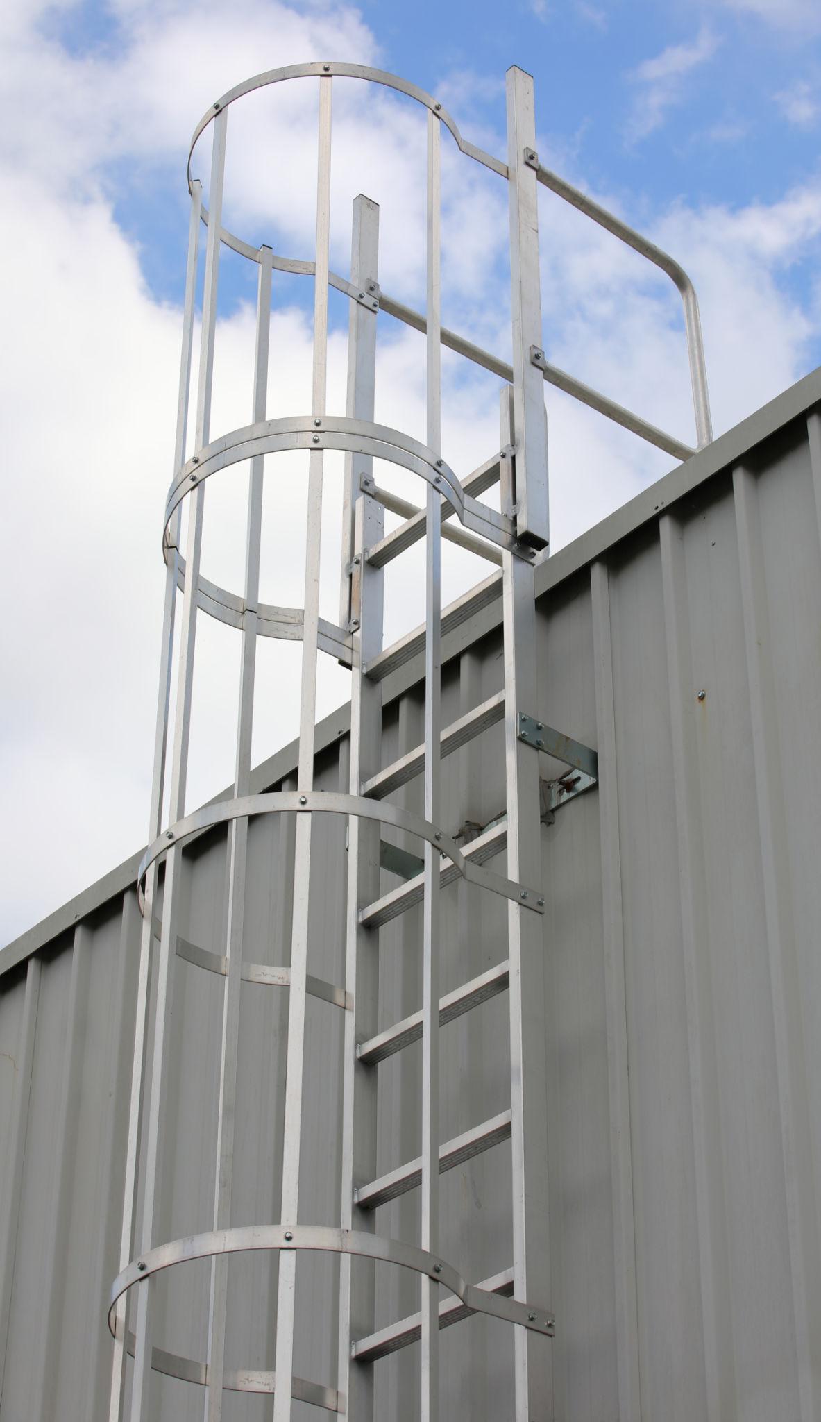 Fixed access ladder with safety cage on industrial building requiring inspection and compliance in Ontario